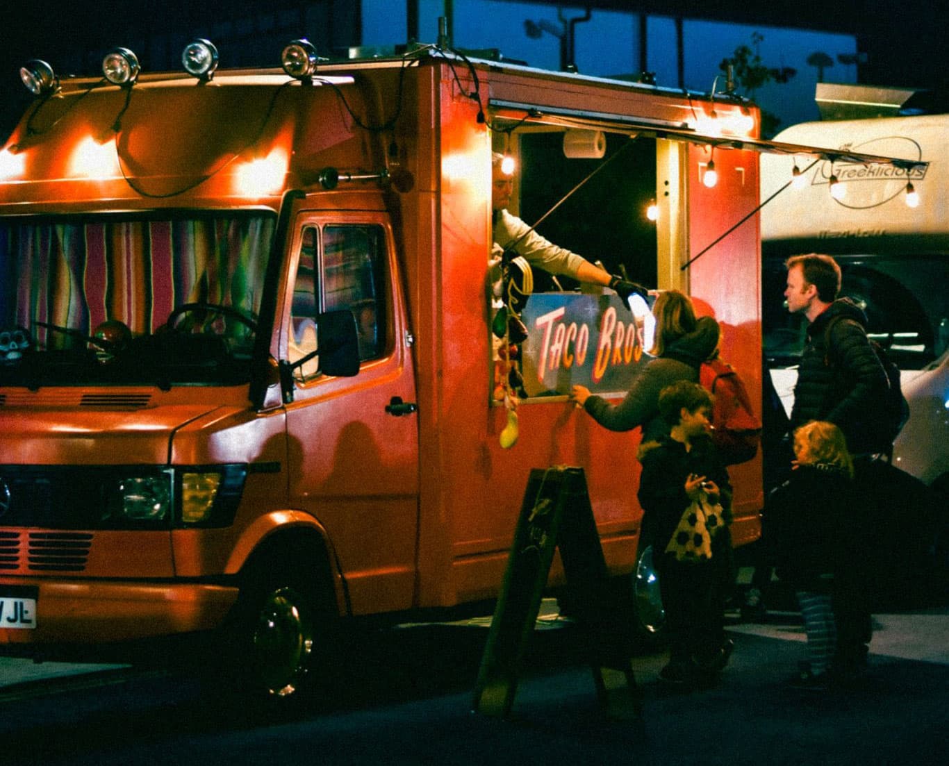 Taco Bros truck at night with customers